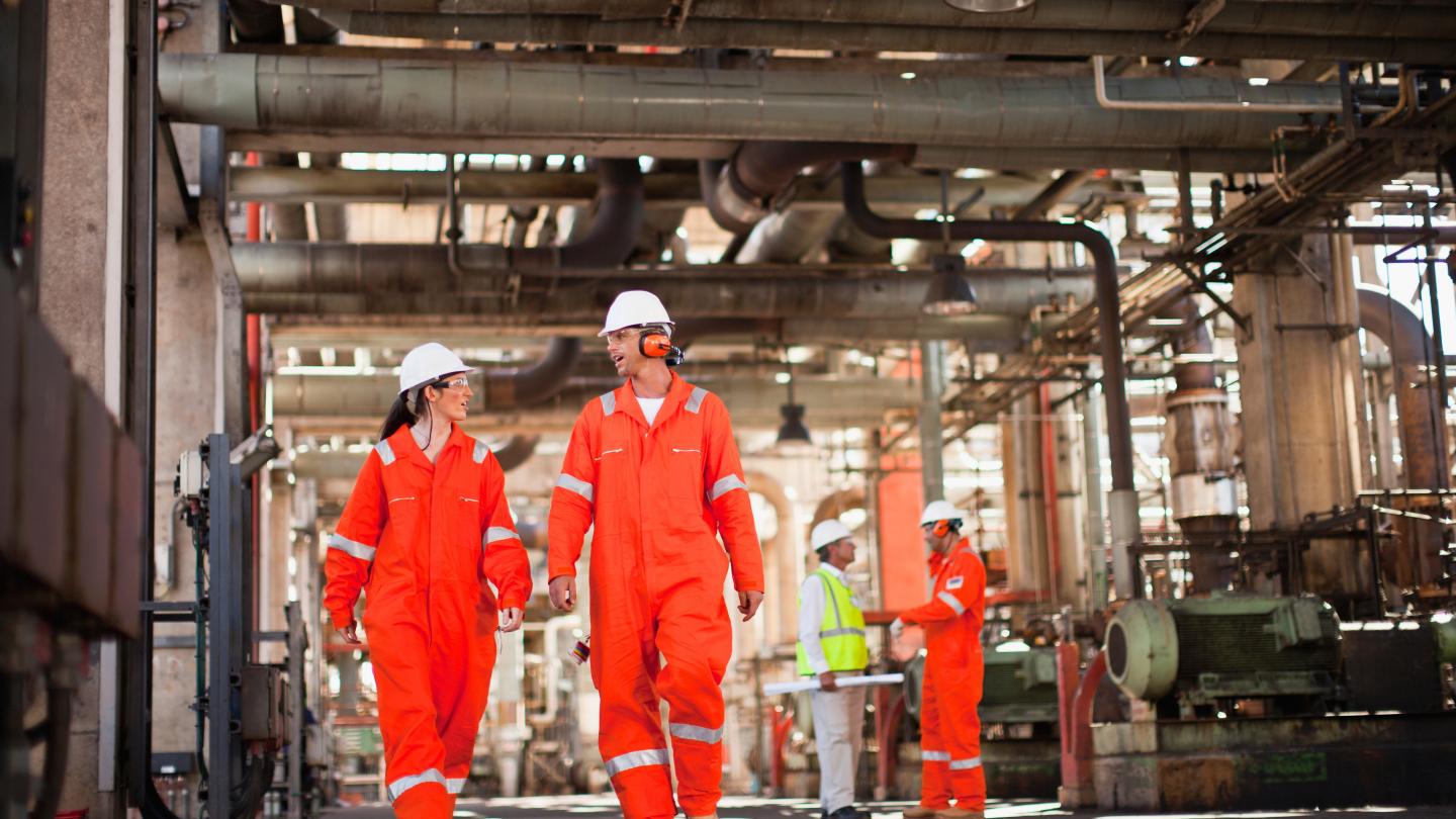 Man and woman walking at petrochemical site