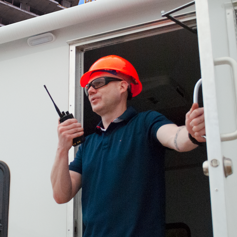Construction worker talking on handheld radio